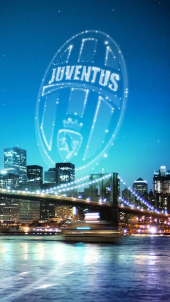 The Juventus Football Club emblem shines brightly above a city skyline at night, HD Phone Wallpaper