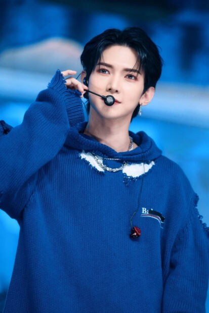 A close up portrait of Kang Yeo Sang wearing a blue sweater and performing on stage, HD Mobile Wallpaper