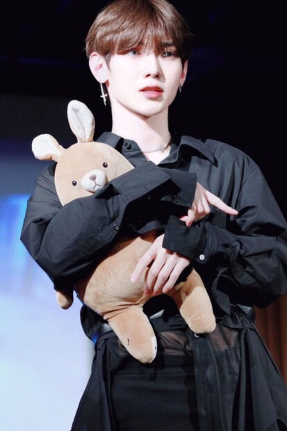 Kang Yeo Sang Wallpapers holding a brown stuffed animal while wearing black clothes, HD Mobile Wallpaper