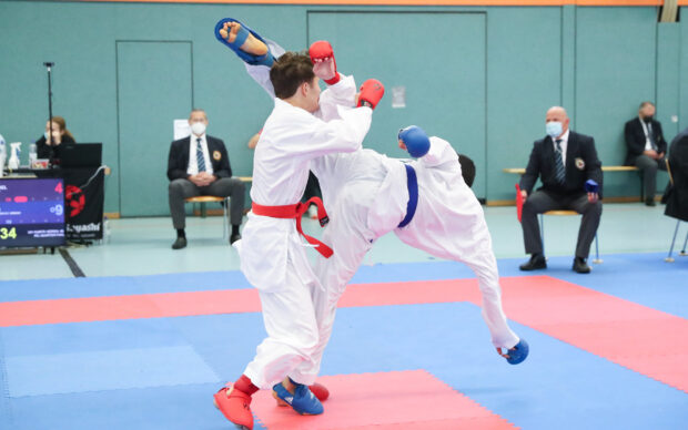 Two karate fighters are competing intensely in a martial arts match, HD Desktop Wallpaper