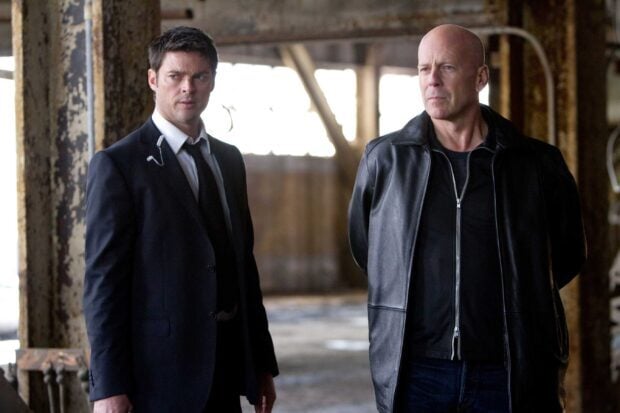 Karl Urban and Bruce Willis standing in a dimly lit industrial space, 2K Desktop Wallpaper