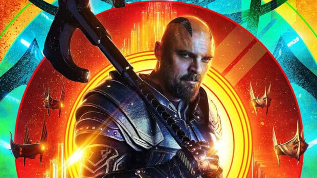 Karl Urban poses with an axe in detailed armor against a vibrant futuristic background, HD Desktop Wallpaper