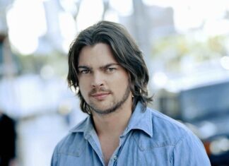 Karl Urban wallpapers showing a close up of a man in a denim shirt with medium length hair, 2K Mobile Wallpaper
