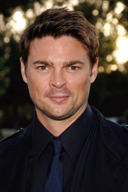 A close up portrait of Karl Urban wearing a dark shirt and tie with a blurred background, HD Phone Wallpaper