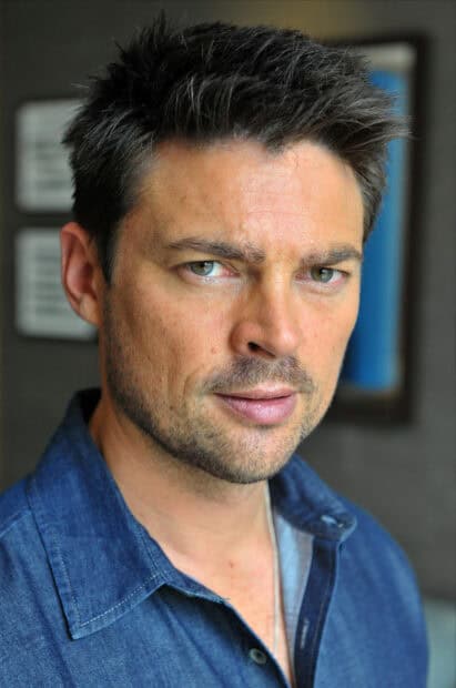A close up portrait of Karl Urban with intense eyes and a blue shirt, HD Mobile Wallpaper