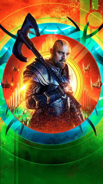 Karl Urban in dark armor holding a large weapon with bright colorful background, HD Phone Wallpaper