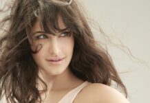 Katrina Kaif is smiling with her flowing hair against a plain background, 4K Desktop Wallpaper