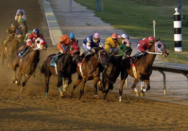 Jockeys compete in the Kentucky Derby horse race on a dirt track, HD Desktop Wallpaper