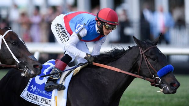 A jockey in colorful gear races a black horse during the Kentucky Derby horse race event, 4K Desktop Wallpaper