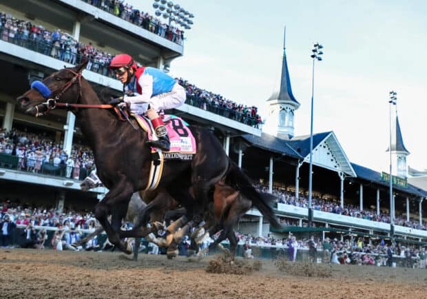 A jockey rides a horse in the exciting Kentucky Derby race with a cheering crowd, 2K Desktop Wallpaper