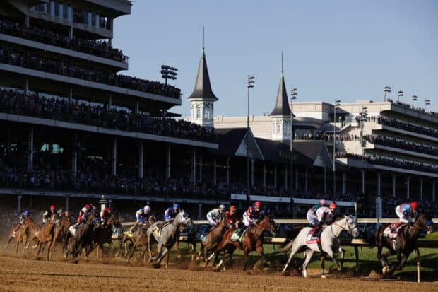 Horses racing fiercely at the Kentucky Derby event with large grandstands, HD Desktop Wallpaper