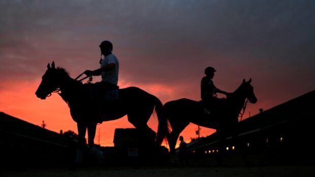 Two jockeys riding horses against a colorful sunset sky at Kentucky Derby, HD Desktop Wallpaper