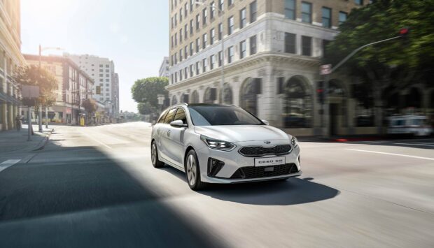 A white Kia Ceed SW is driving through a city street in the daytime Kia Wallpapers 4K and Full HD, HD Desktop Wallpaper