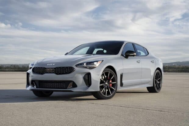 A white Kia Stinger is parked on concrete under a cloudy sky, HD Desktop Wallpaper