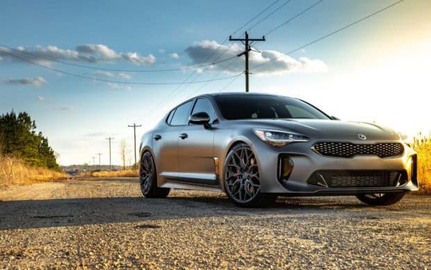 A Kia Stinger is parked on a gravel road with a sunset sky in the background, HD Desktop Wallpaper