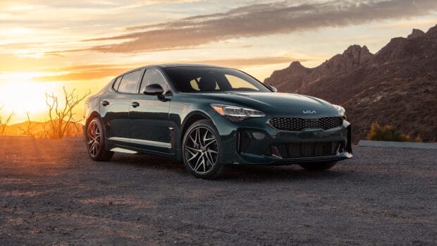 A Kia Stinger car parked on a mountain road during sunset, HD Desktop Wallpaper