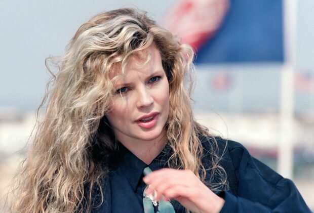 Kim Basinger looks thoughtful in a casual outfit with curly hair, HD Desktop Wallpaper