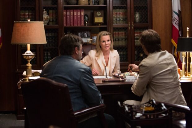 Kim Basinger engages in a serious discussion with two men in an office setting, HD Desktop Wallpaper
