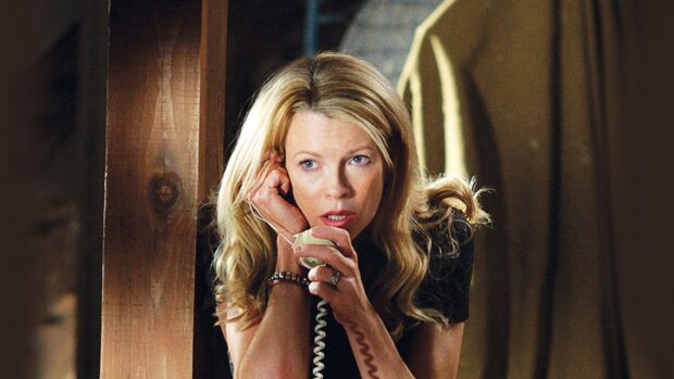 Kim Basinger holds a phone with a focused expression during a tense moment, 2K Desktop Wallpaper