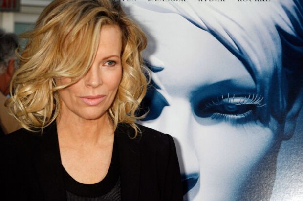 Kim Basinger posing at a film premiere with a poster behind her, HD Desktop Wallpaper