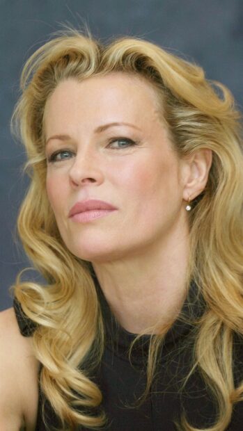 A close up of Kim Basinger showing her wavy blonde hair and contemplative expression, HD Mobile Wallpaper