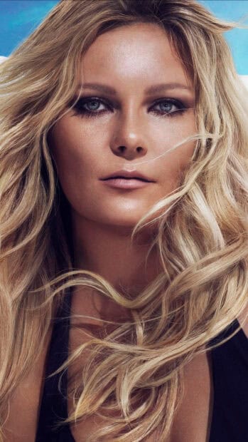 Kirsten Dunst looks directly into the camera with flowing blonde hair, HD Phone Wallpaper