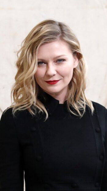Kirsten Dunst wears a black outfit with red lipstick in this portrait, 2K Mobile Wallpaper