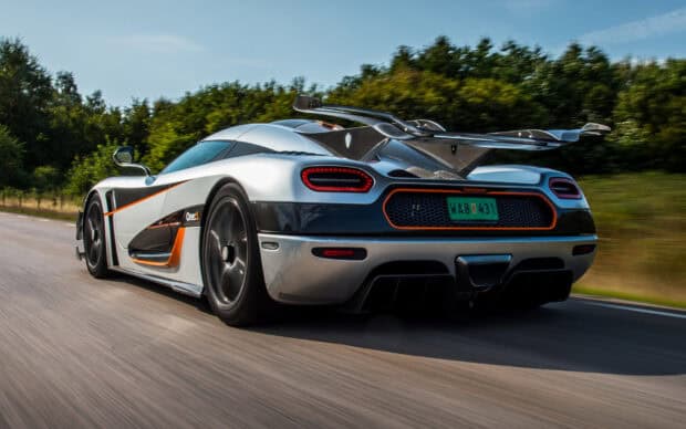 A silver Koenigsegg driving fast on a road surrounded by trees with motion blur, HD Desktop Wallpaper