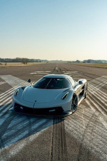 A silver Koenigsegg is parked on an empty runway under a clear sky, HD Mobile Wallpaper