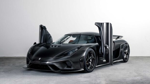 A Koenigsegg is shown with its doors open in a studio setting, blending luxury and performance, HD Desktop Wallpaper