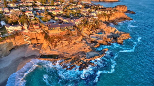 Aerial view of Laguna Beach coastline with rocky cliffs and blue waves, HD Desktop Wallpaper