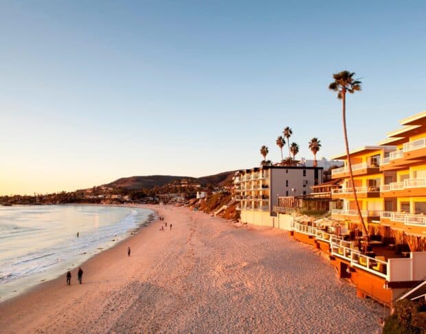 The Golden Hour lights up Laguna Beach with palm trees and sandy shores, 2K Desktop Wallpaper