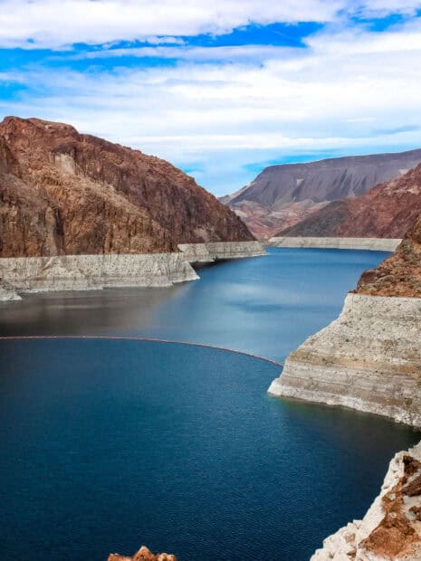 The Lake Mead showcases calm water surrounded by rocky cliffs under a cloudy sky, HD Mobile Wallpaper