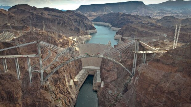 A wide aerial view shows Lake Mead dam and the vast canyon landscape around it, HD Desktop Wallpaper