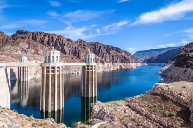 A view of Lake Mead with clear water and rocky surroundings under a blue sky, HD Desktop Wallpaper