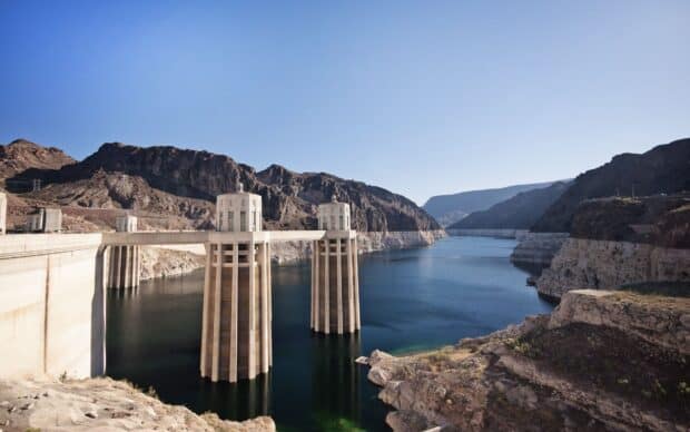 The Lake Mead water intake towers stand tall against rocky mountains under a clear sky, HD Desktop Wallpaper