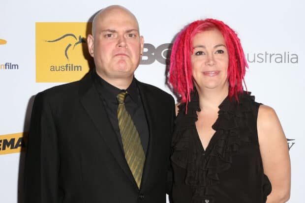 Lana Wachowski wallpapers featuring a woman with bright pink hair and a man in a black suit at an event, 2K Desktop Wallpaper
