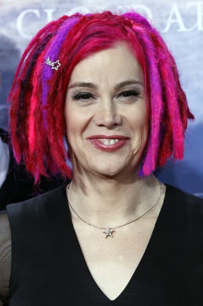 Lana Wachowski with pink and purple dreadlocks smiling at an event, 2K Desktop Wallpaper