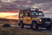 A Land Rover Defender is parked on a muddy track at sunset in a rural setting, 4K Desktop Wallpaper
