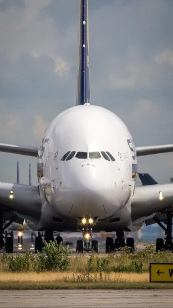 Airbus A380 is positioned on the runway ready to taxi under cloudy sky, HD Mobile Wallpaper