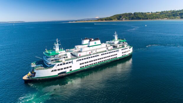 A large ferry is cruising through calm waters near a green coastline under a clear blue sky, 4K Desktop Wallpaper