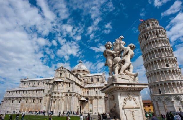 The Tower of Pisa is captured with sculptures and a partly cloudy sky, HD Desktop Wallpaper