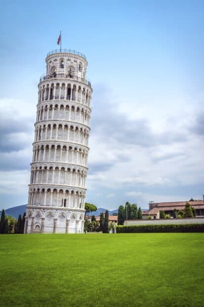 The Leaning Tower of Pisa stands tall with a cloudy sky and green grass around it, HD Phone Wallpaper