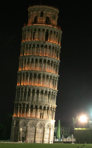 The Tower of Pisa stands brightly lit against the night sky, 2K Mobile Wallpaper