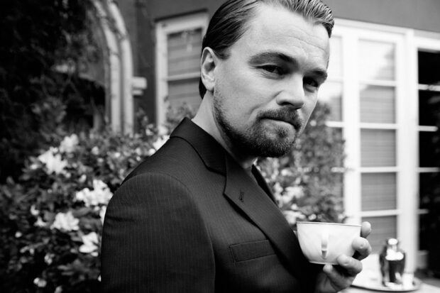 Leonardo Dicaprio holding a cup in a close up black and white portrait, 2K Desktop Wallpaper