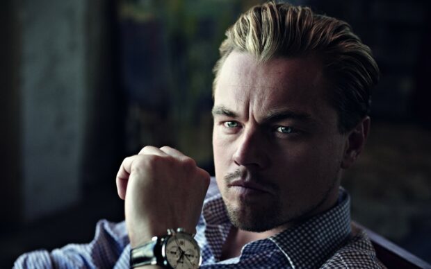Leonardo Dicaprio looks thoughtfully with his fist raised showing a wristwatch, 2K Desktop Wallpaper
