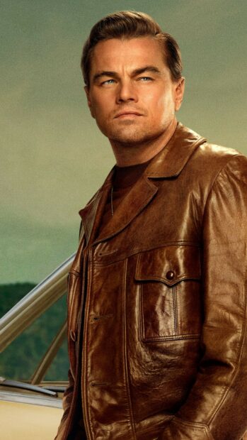Leonardo Dicaprio stands wearing a brown leather jacket looking into the distance, HD Phone Wallpaper