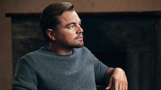 Leonardo Dicaprio is sitting and looking thoughtfully to the side in a cozy setting, HD Desktop Wallpaper