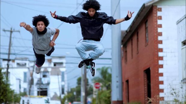 The Les Twins are captured mid air performing a jump on a city street, HD Desktop Wallpaper