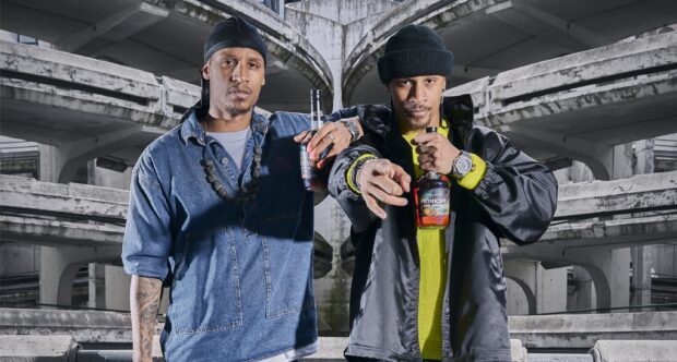 Les Twins posing under concrete structure holding bottles of Hennessy, 2K Desktop Wallpaper